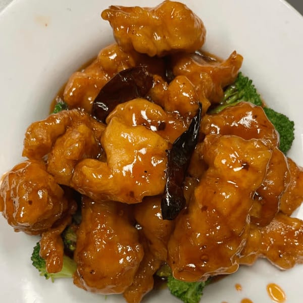 King's Chinese General Tso's chicken with broccoli and dried chilies in a white bowl.